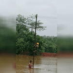 Mescom staff's work in repairing electricity poles in floodwaters