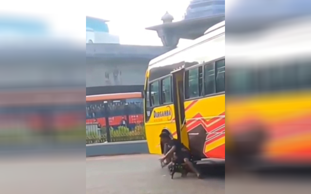 Cyclist falls under bus, miraculously escapes unhurt